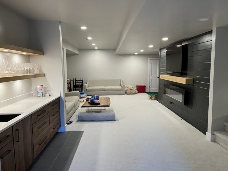 Finished Whitmore Lake basement with a kitchenette, wood cabinets and a sectional in the family room