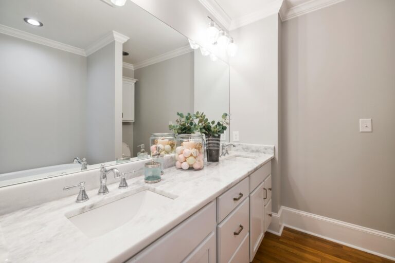 Powder room with a wood vanity and round mirror