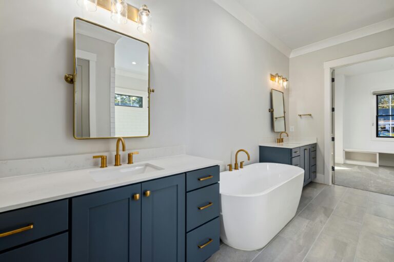 Freestanding soaking tub beside a glass walk-in shower