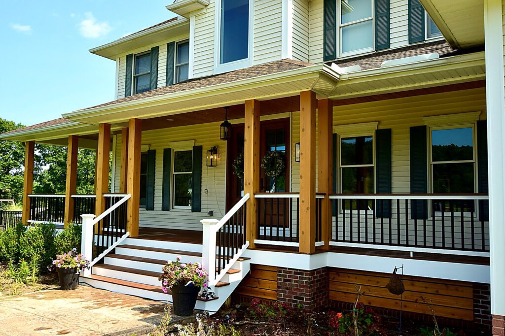 Full wraparound porch on a yellow two-story farmhouse