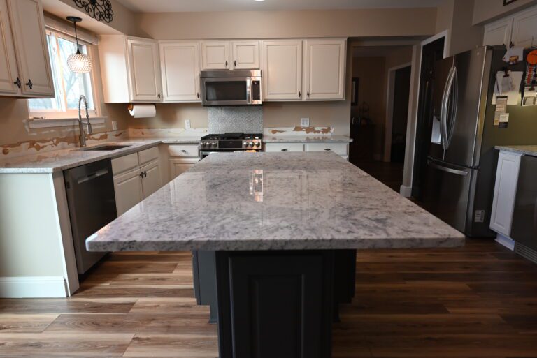 Granite countertop detail with white cabinetry
