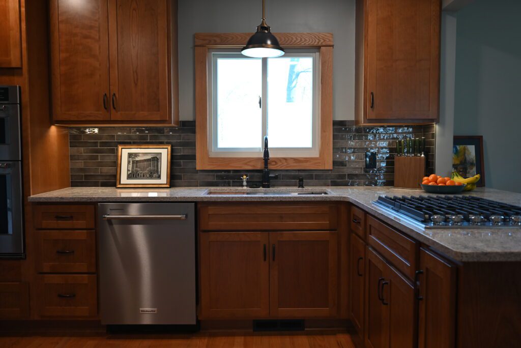 Kitchen with wood cabinets, stone countertops, and stainless appliances (DSC_1090)