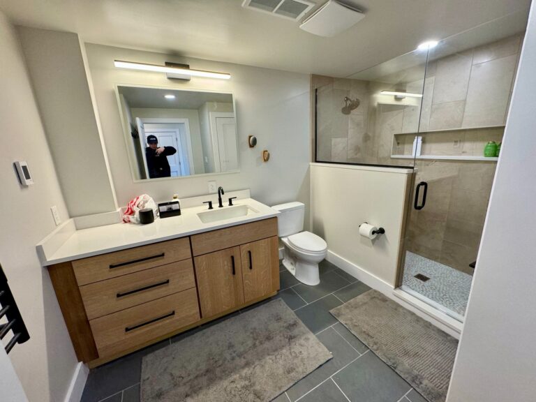 Basement bathroom vanity with sink and mirror