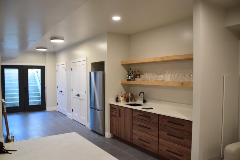 Built-in shelving with cabinet doors in a finished basement