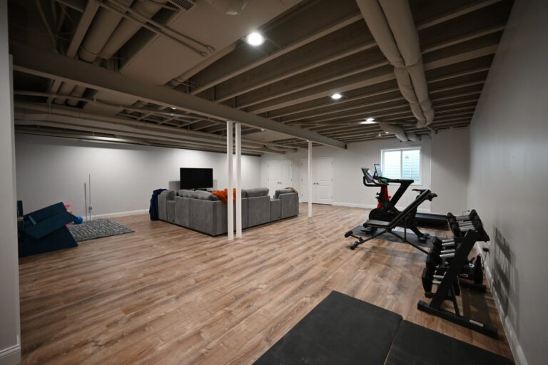 Basement family room with sectional and home gym corner