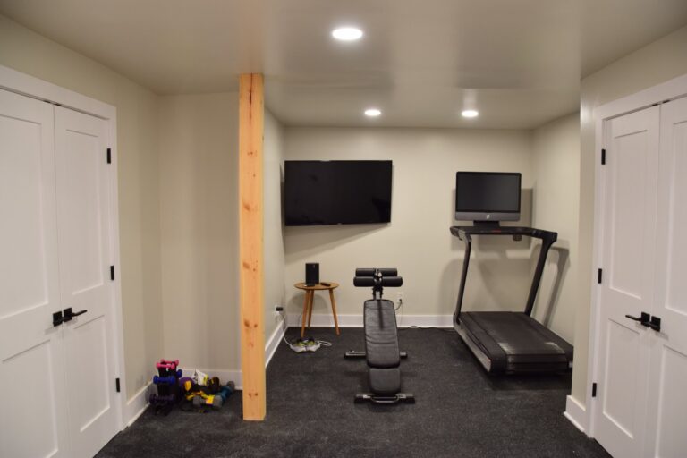 Basement home gym with treadmill and wall-mounted TV
