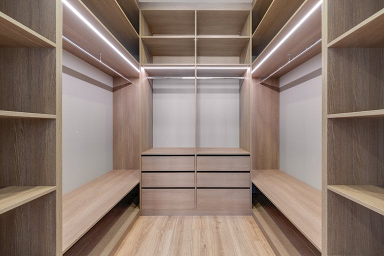 Walk-in closet with dark built-in wardrobes