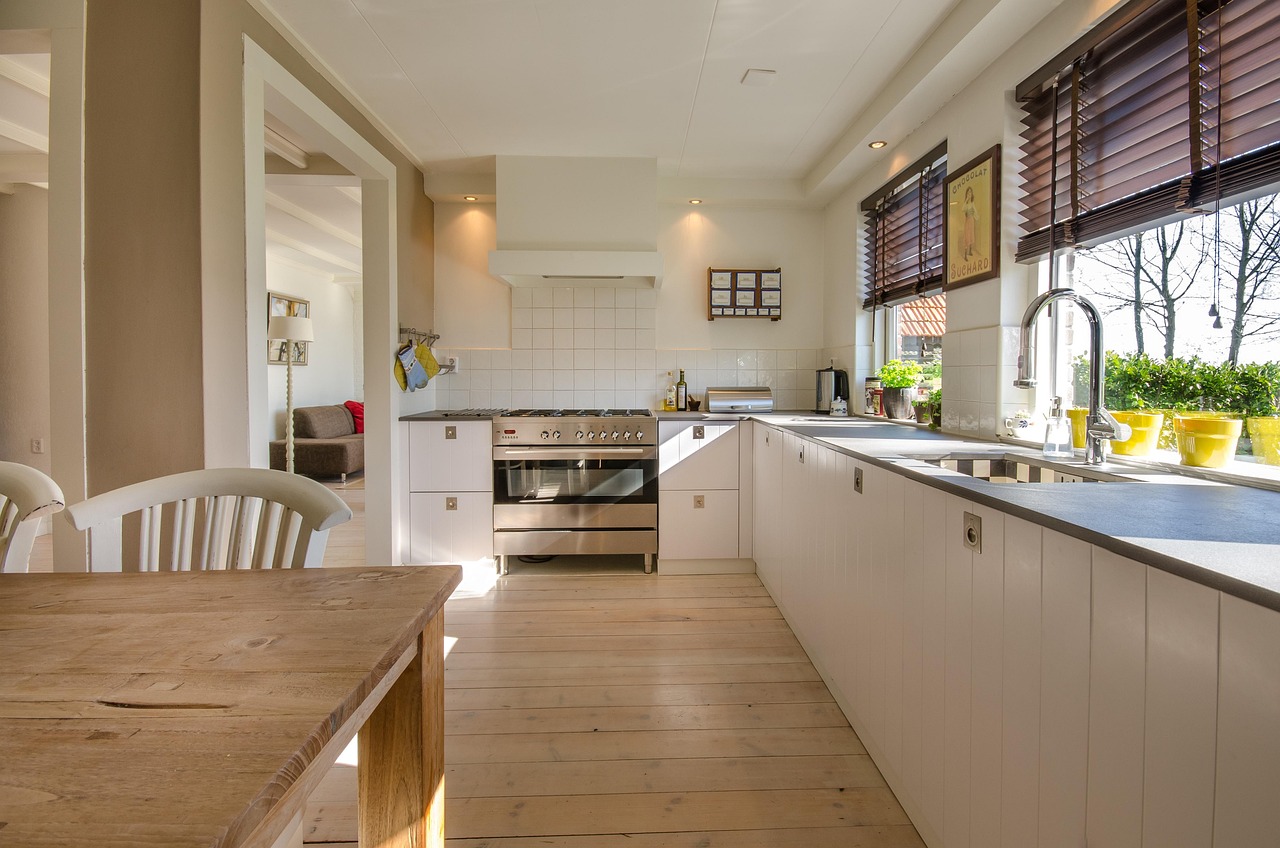 Modern kitchen renovation with white cabinets and natural light by Wright's Renovations