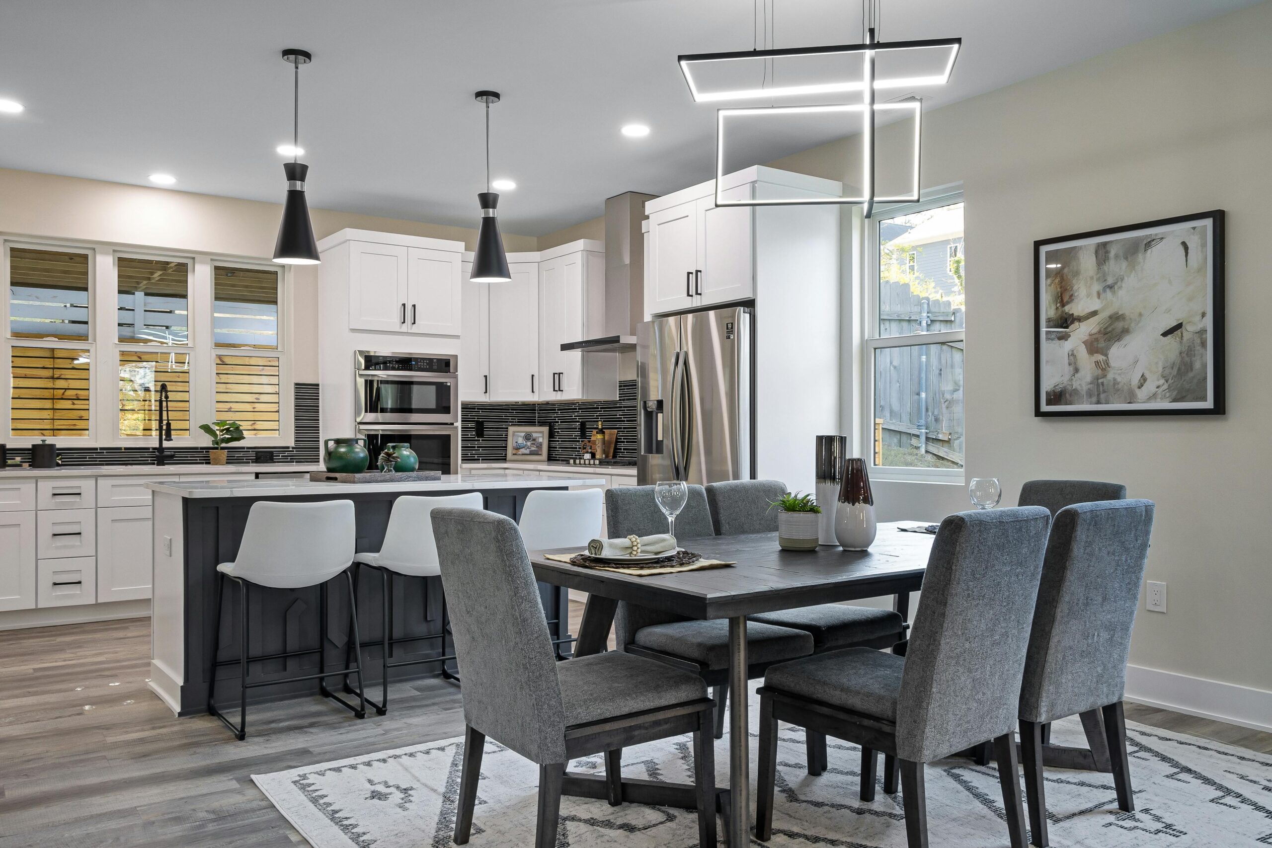 A finished open-concept kitchen and dining area with quartz countertops and a large island.