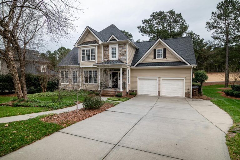 Home exterior with attached garage and fresh landscaping