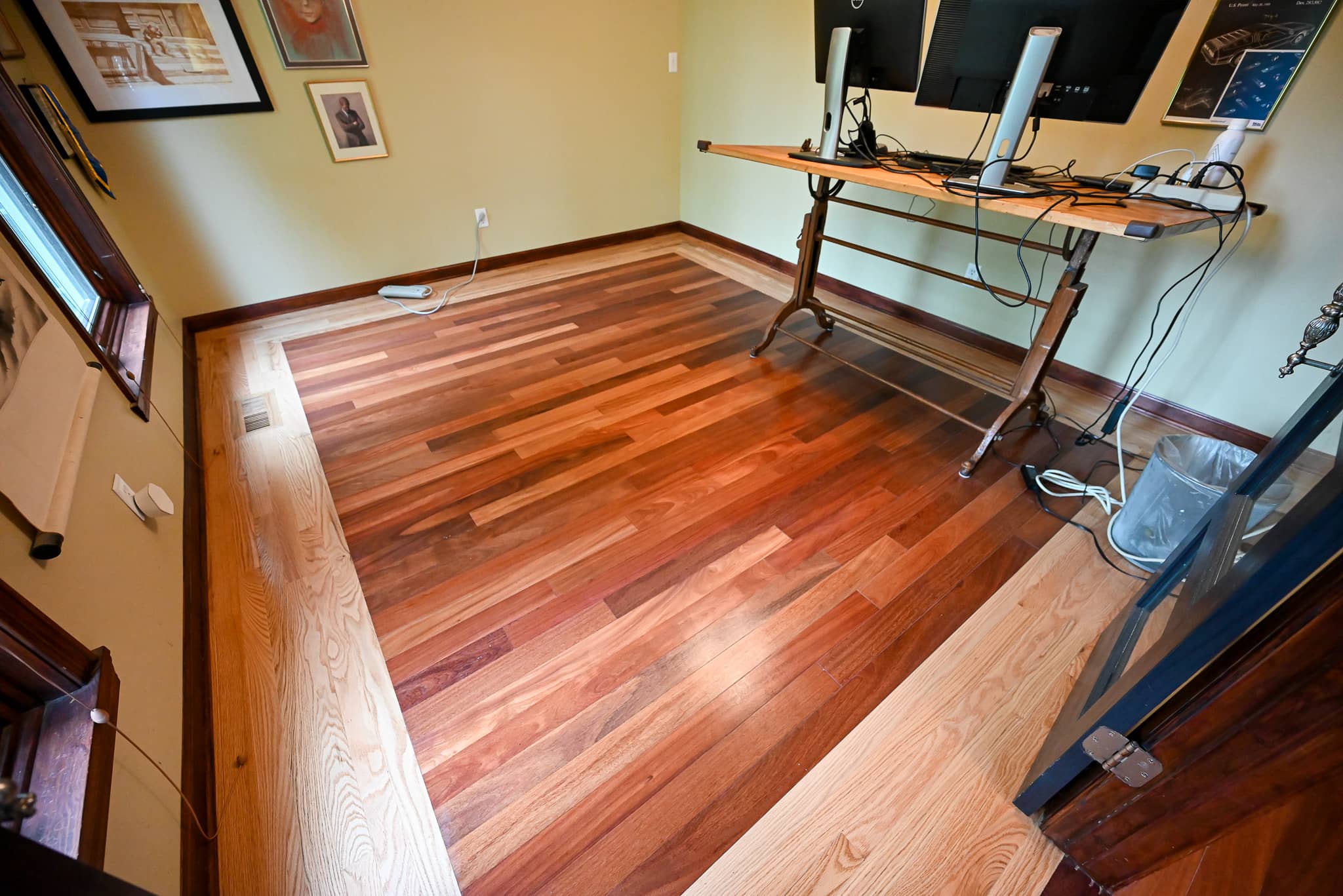 Room with freshly refinished hardwood floors and large windows