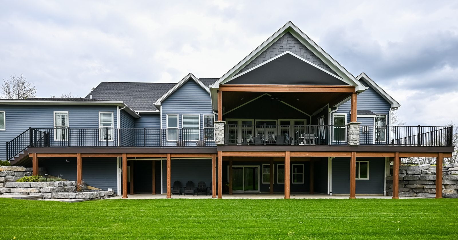 Rear of an Ann Arbor home with cedar-wrapped posts and beams supporting a full-width deck