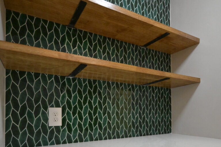 Ann Arbor dry bar with a green tile backsplash and butcher block shelves above a white counter