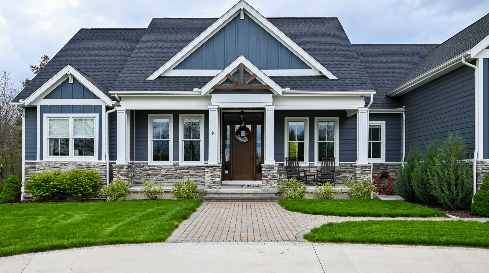 Craftsman-style Ann Arbor home with refreshed white front porch posts and a timber gable accent