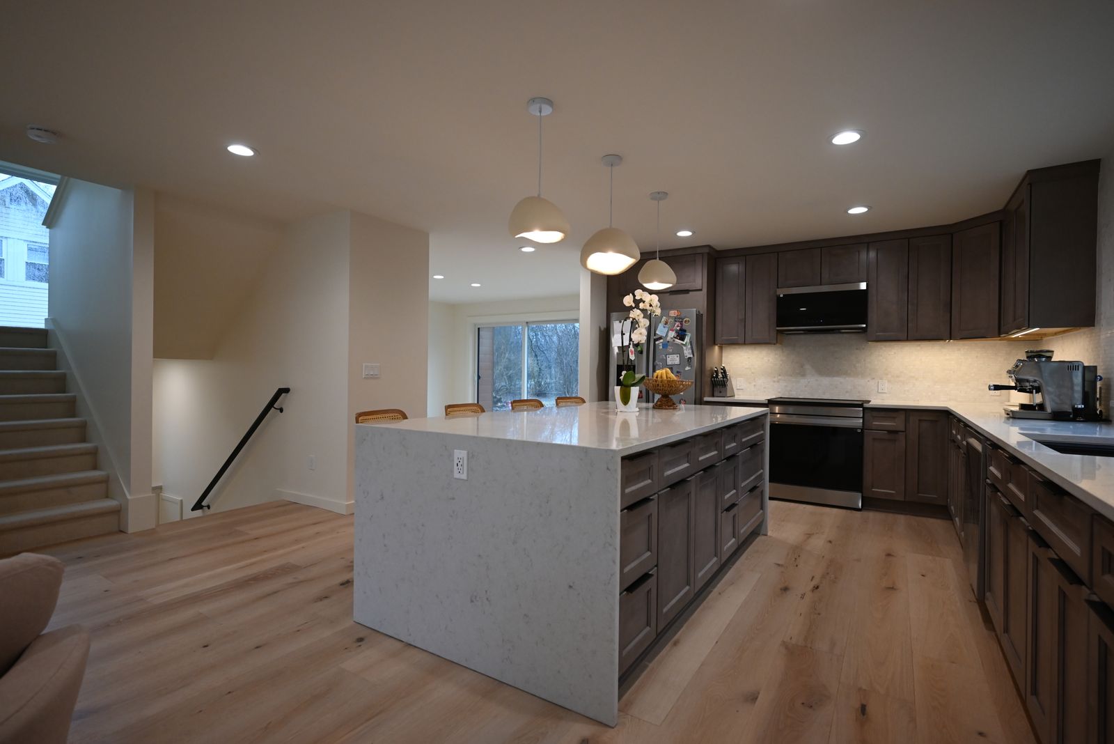 Open kitchen and great room with a staircase after a whole home addition in Ann Arbor
