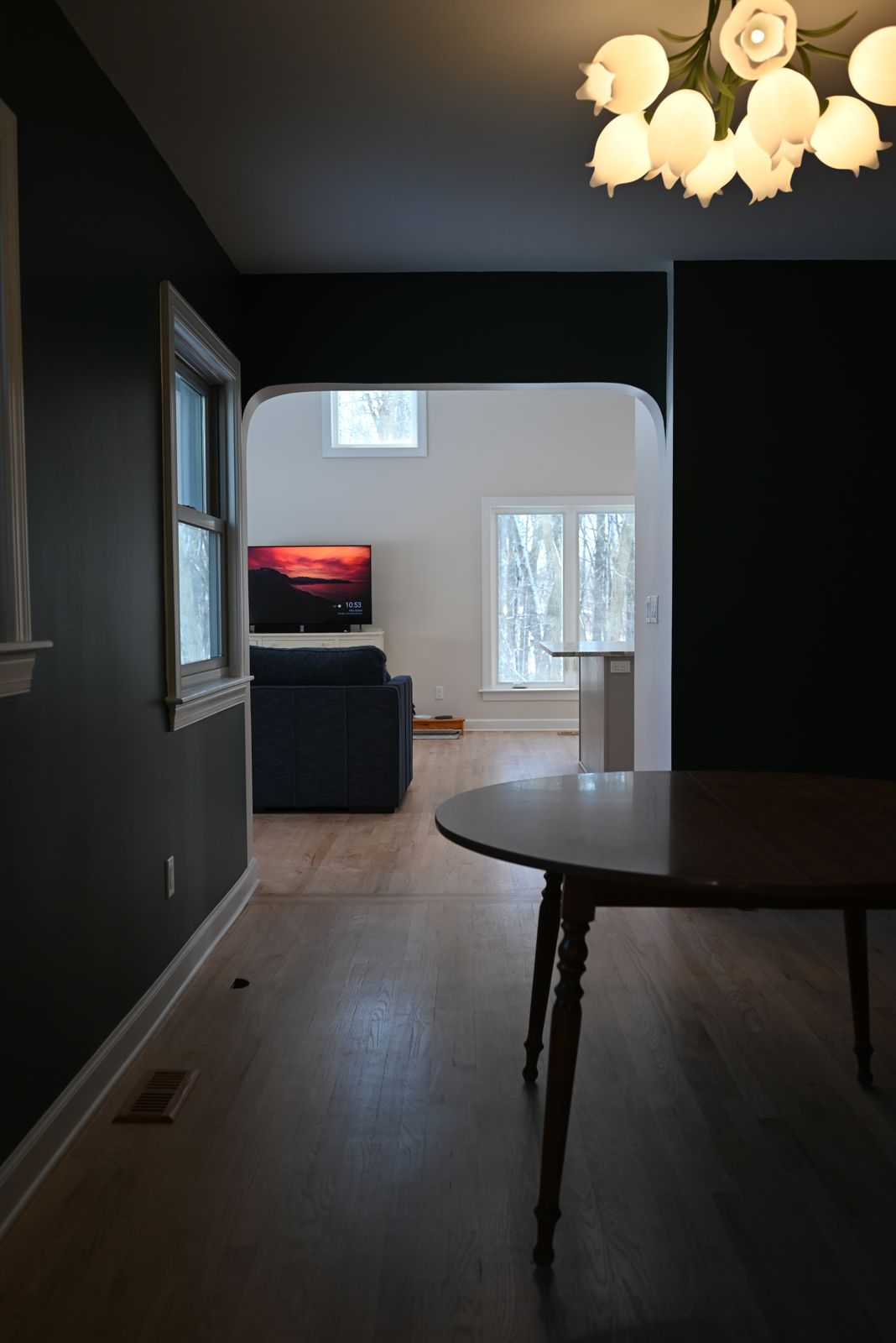 Dining area with a tulip chandelier off the main living space in Ann Arbor
