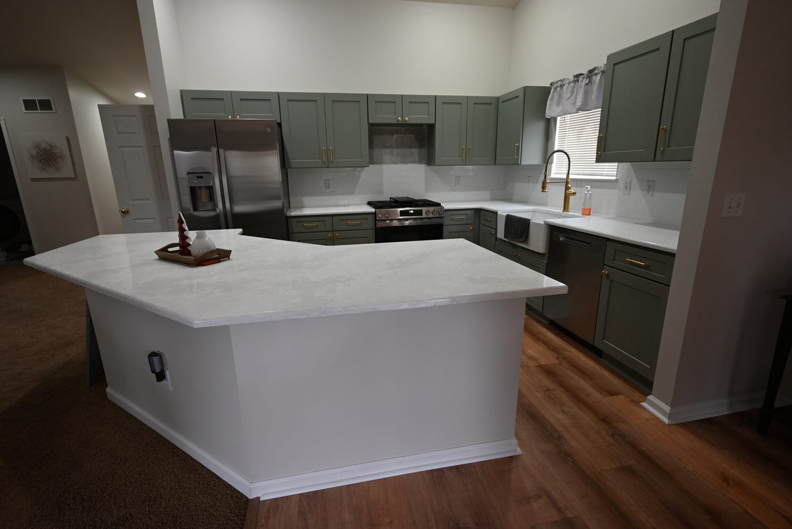 Remodeled kitchen in Belleville with sage green cabinets and white quartz countertops