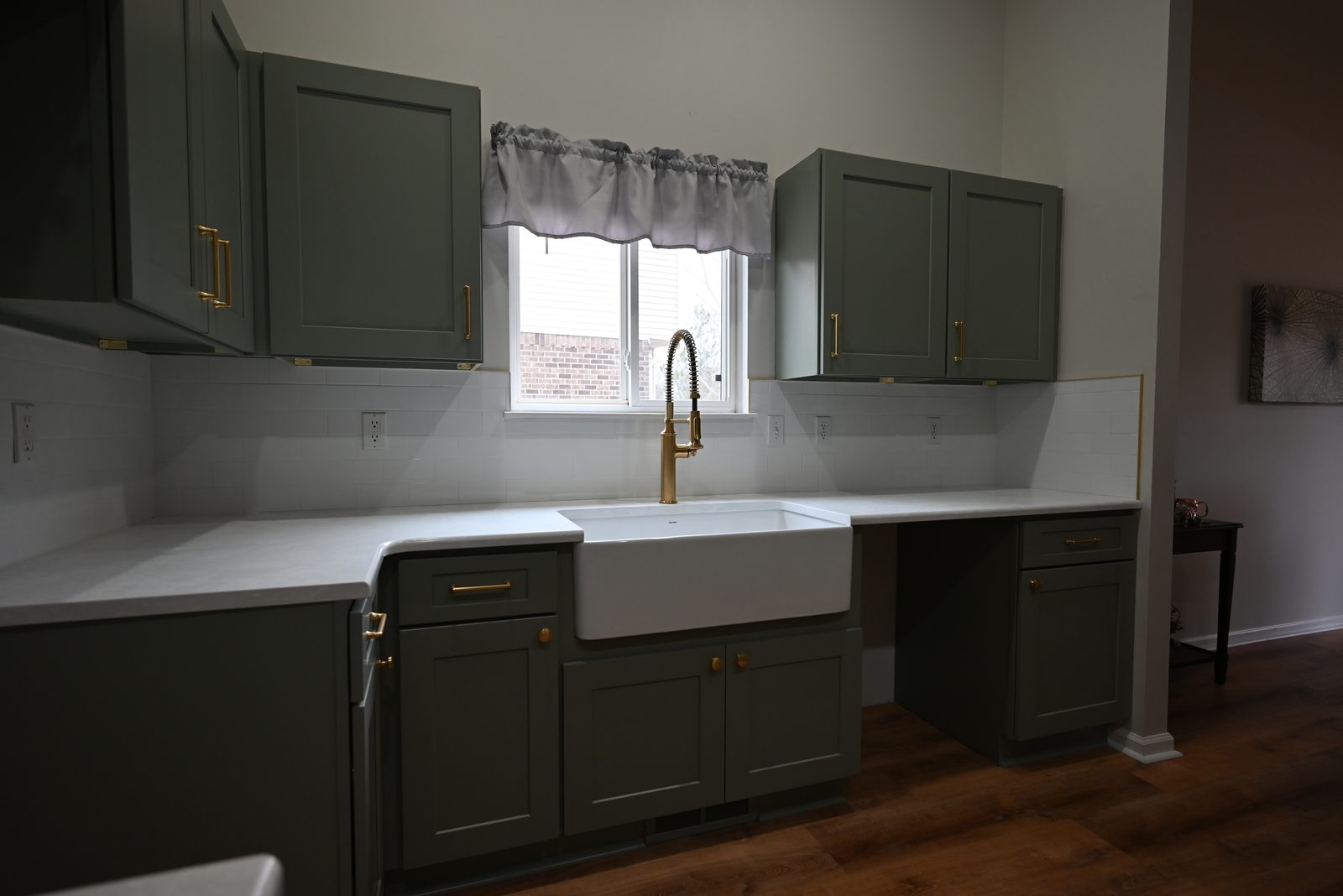 Kitchen sink area with new counters beneath a window in a Belleville remodel