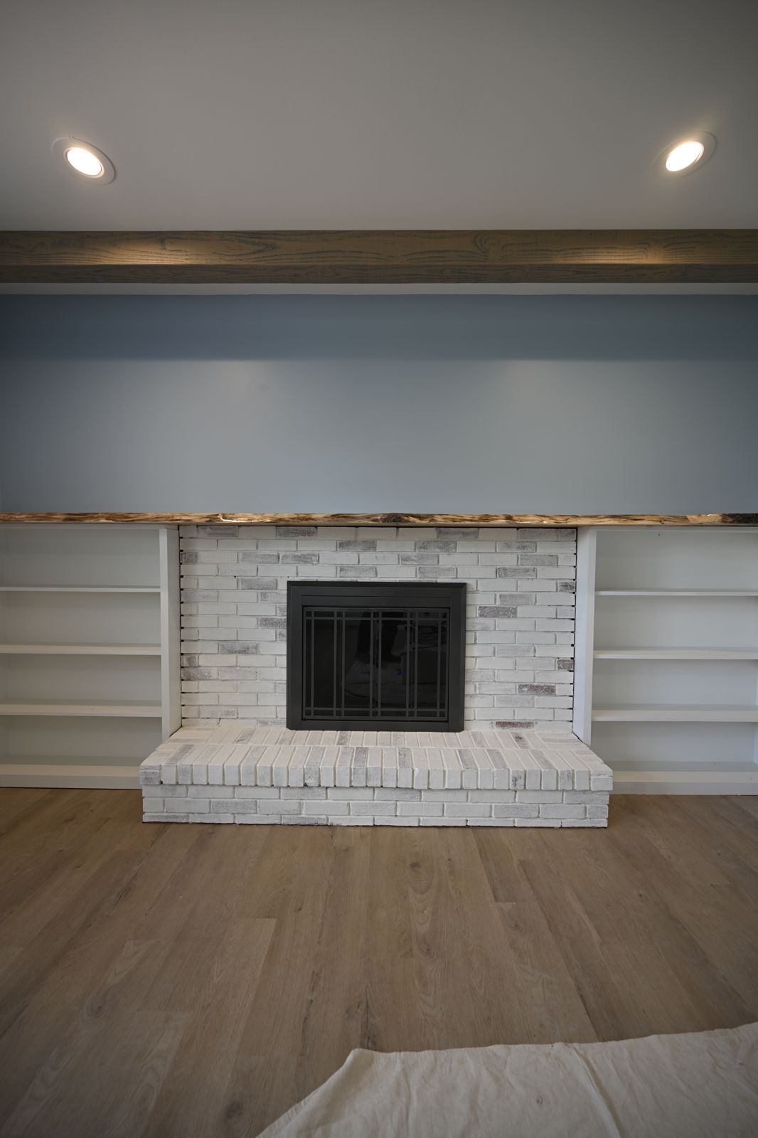 New wide-plank floors and recessed lighting in the Canton living room