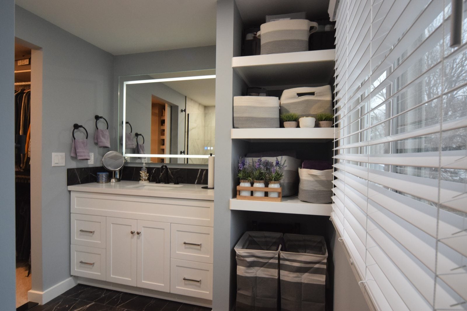 Remodeled Livonia bathroom with a floating vanity and backlit mirror