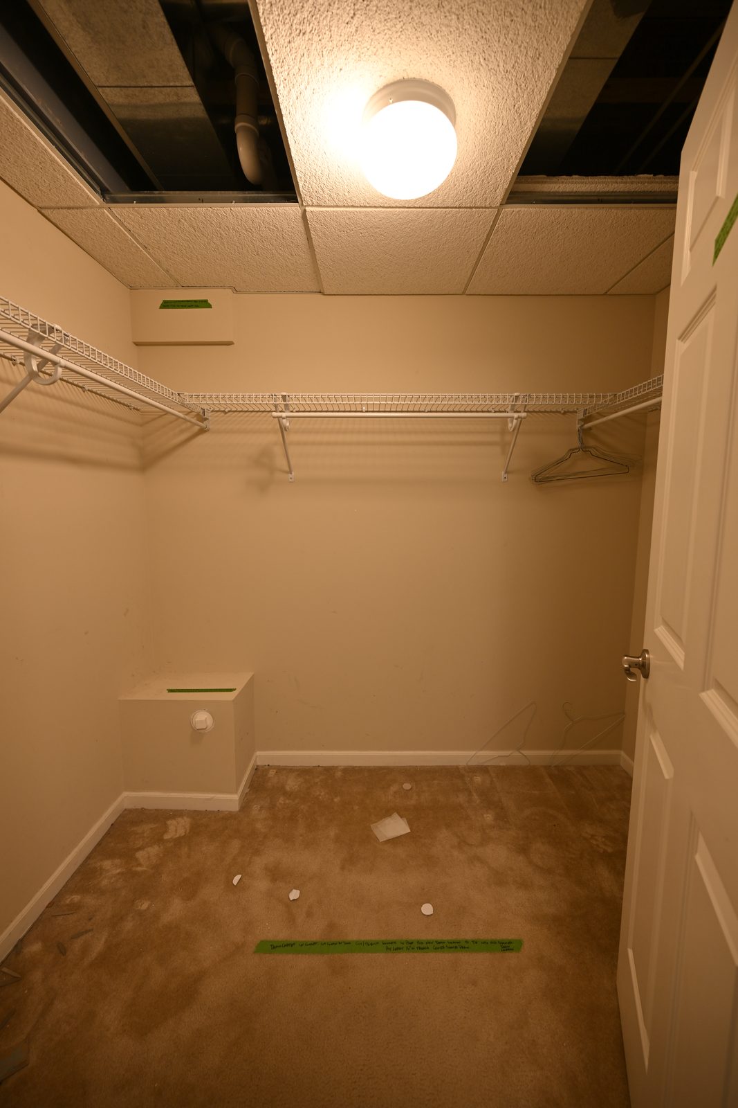 Walk-in closet with wire shelving before its conversion into a walk-in shower