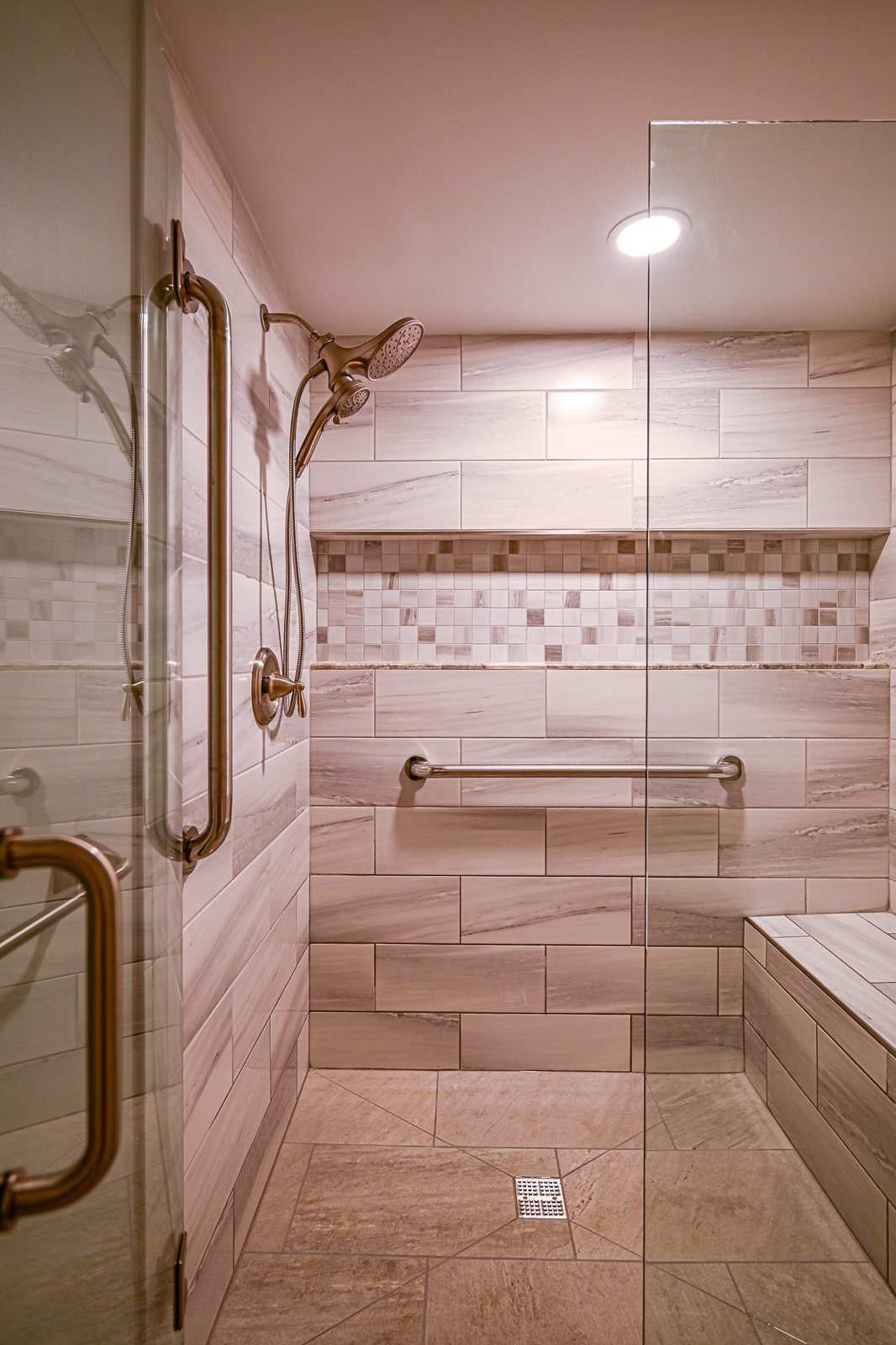 Frameless glass door opening into the walk-in shower of a Plymouth basement bathroom