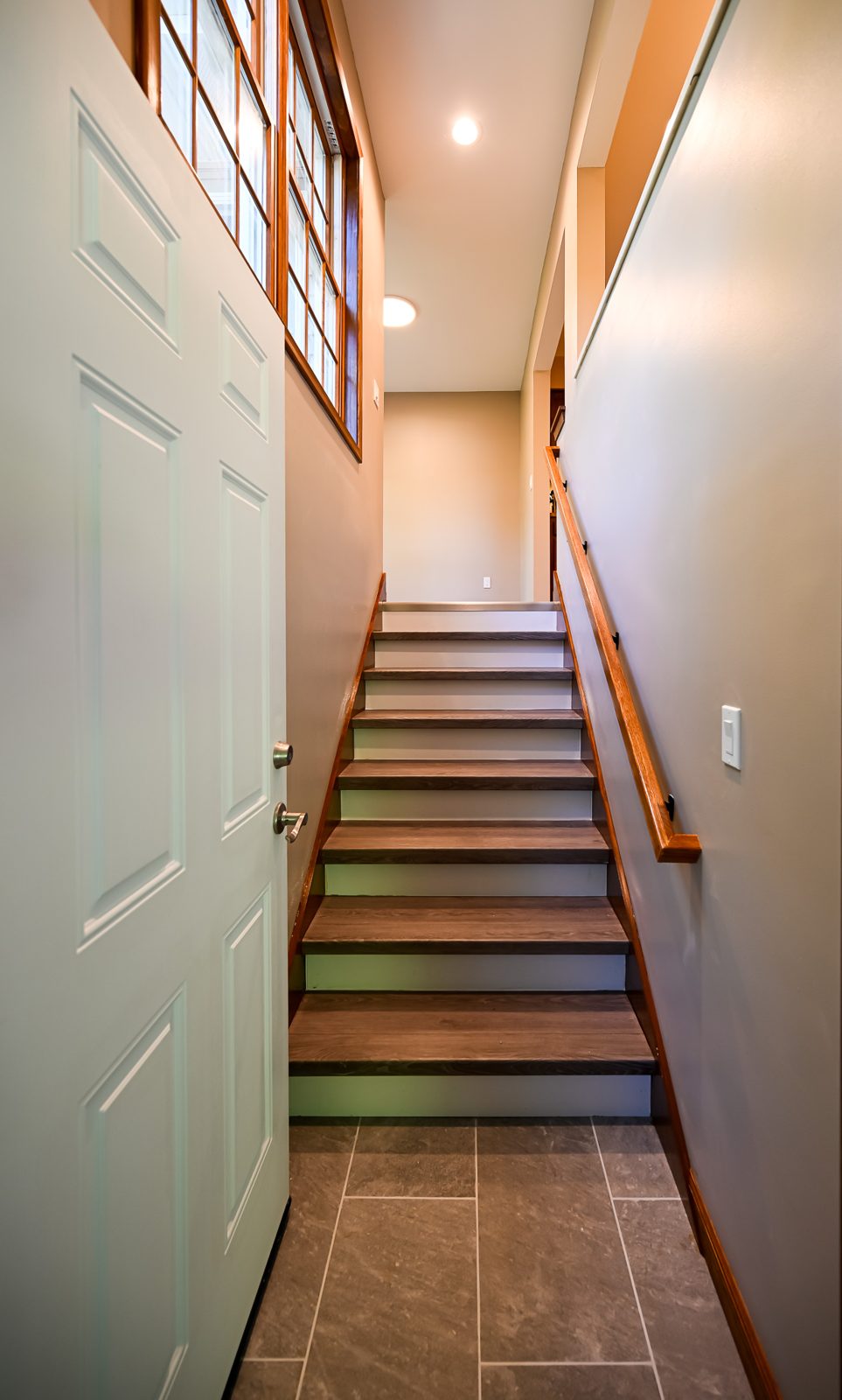 New breezeway staircase with wood treads connecting the mudroom to the garage in Saline