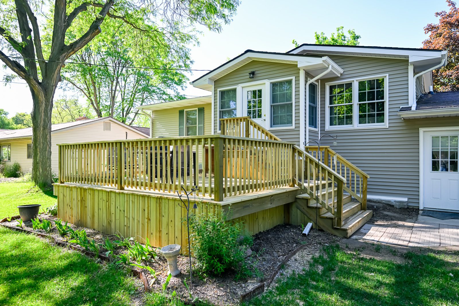 Re-topped deck with new lattice skirting behind the Saline mudroom addition