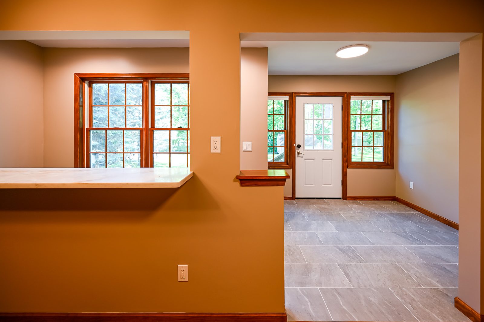 Saline mudroom with a breakfast bar counter, divided-light windows and a new entry door