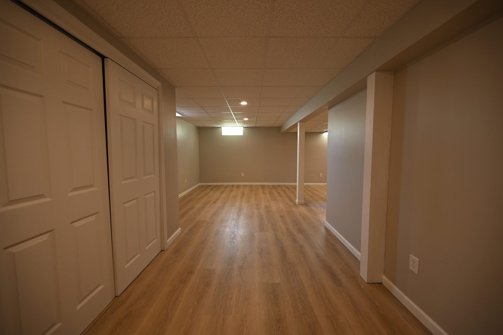 Sliding closet doors along a refinished basement hallway in Ypsilanti