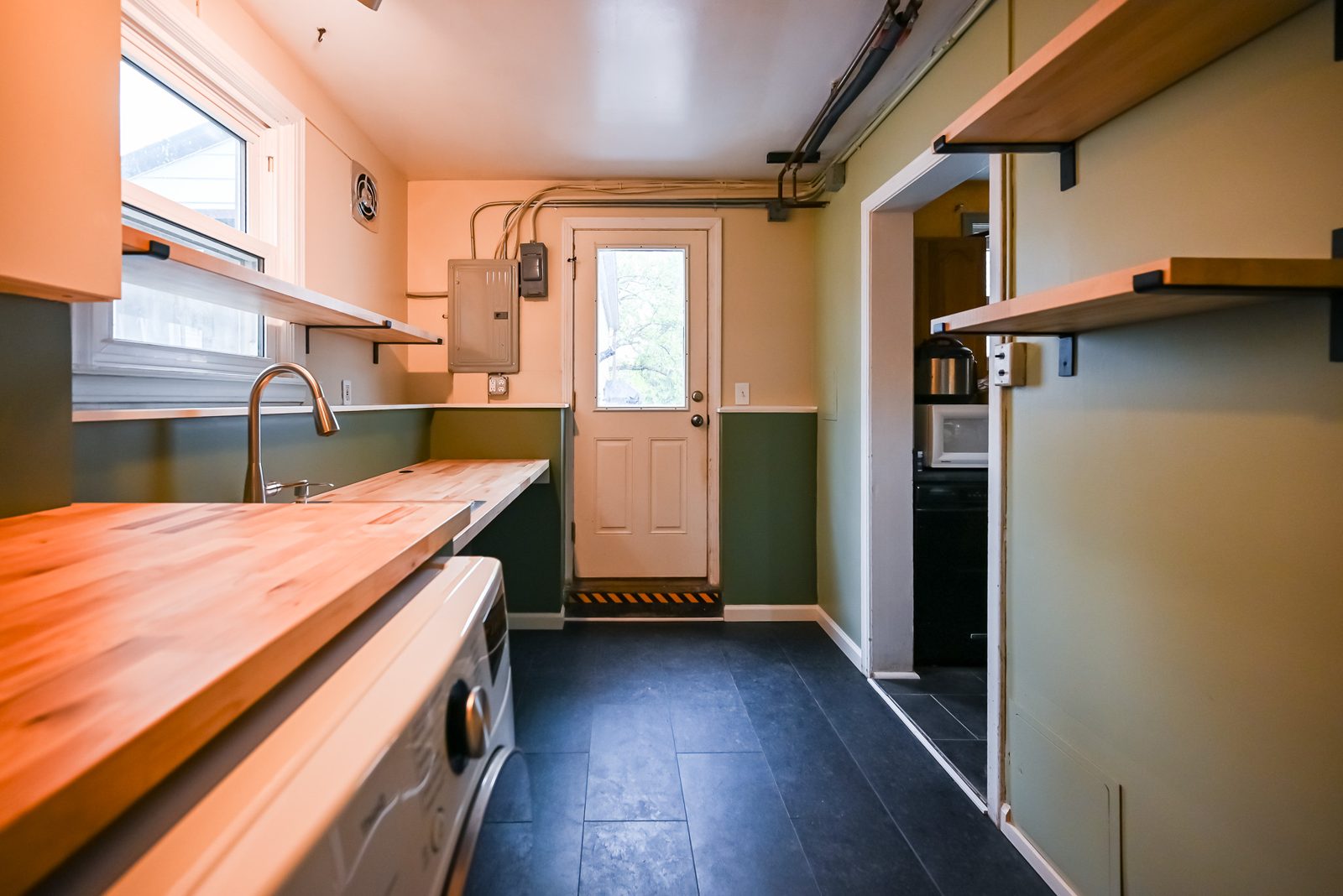 New vinyl plank flooring leading from the Ypsilanti laundry room toward the kitchen door
