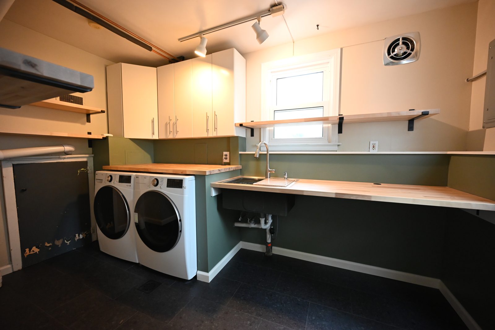 New utility sink, open shelf and window in the remodeled Ypsilanti laundry room