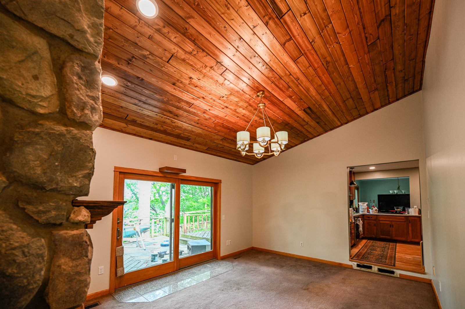 Sliding glass door with a floating projector shelf above it in a remodeled Ypsilanti living room