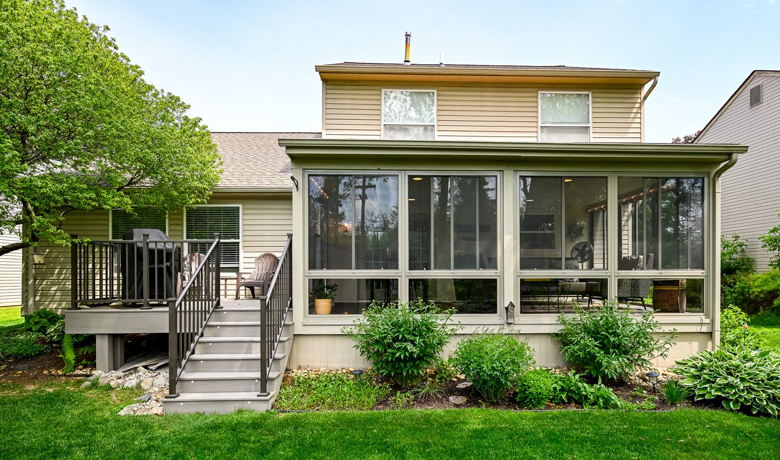 Rear exterior of an Ypsilanti home showing the enclosed porch and re-topped composite deck