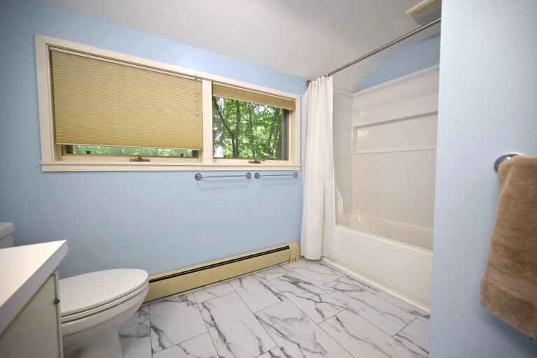 Remodeled Ann Arbor bathrooms with a tiled walk-in shower and a new tub bath