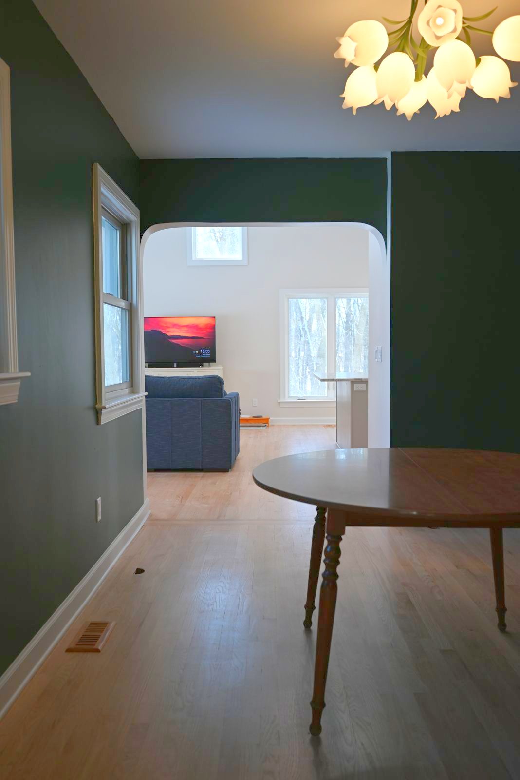 Dining area with a tulip chandelier off the main living space in Ann Arbor