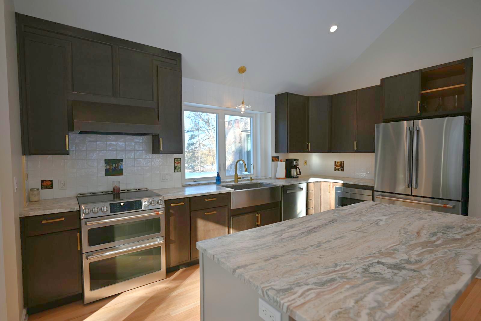 Remodeled kitchen with dark cabinetry and stone counters in Ann Arbor