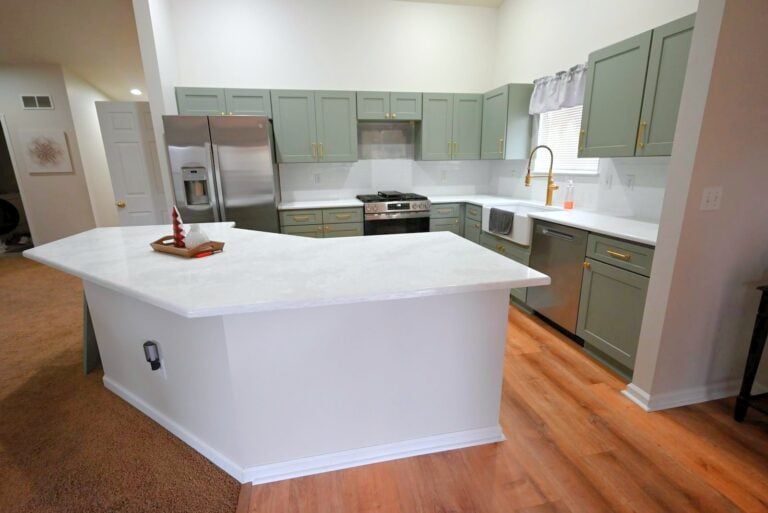 Remodeled kitchen in Belleville with sage green cabinets and white quartz countertops
