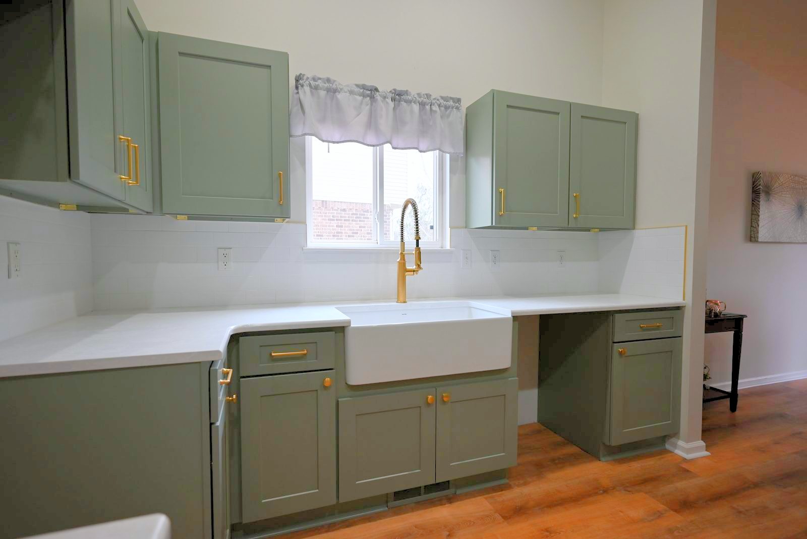Kitchen sink area with new counters beneath a window in a Belleville remodel