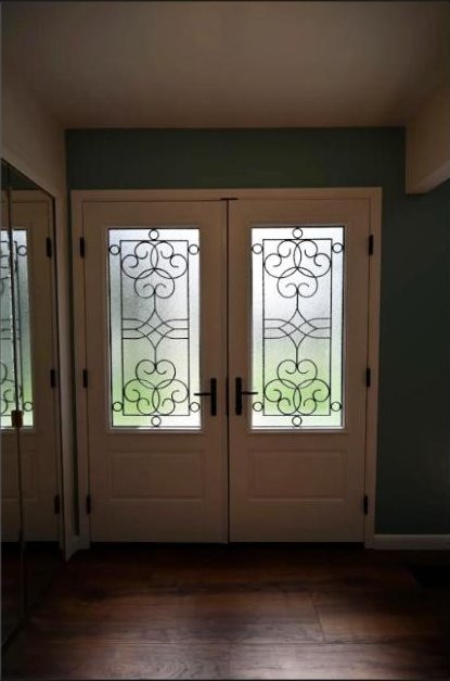 Front entry with leaded glass doors and dark hardwood in the Canton whole home remodel
