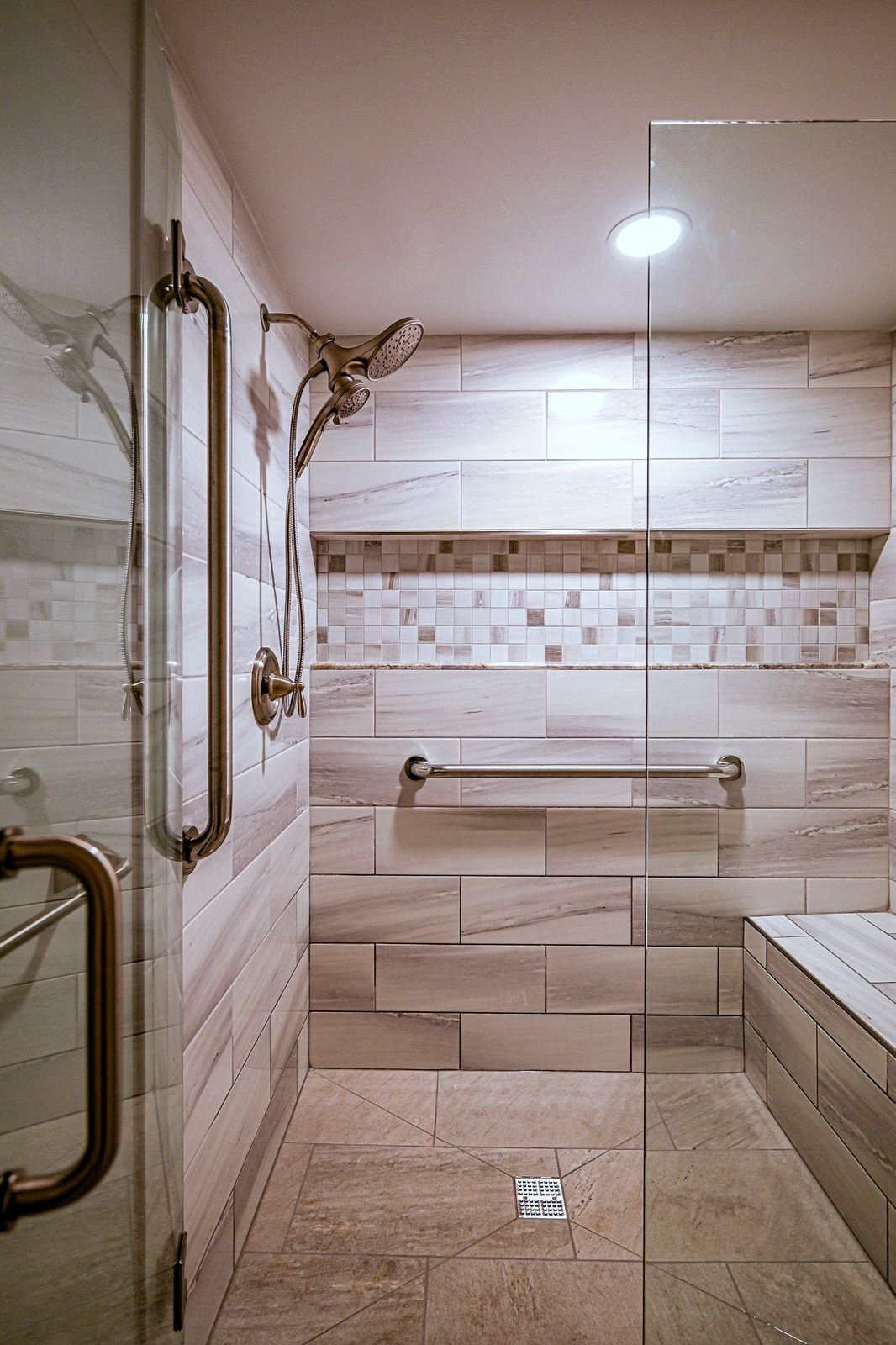 Frameless glass door opening into the walk-in shower of a Plymouth basement bathroom