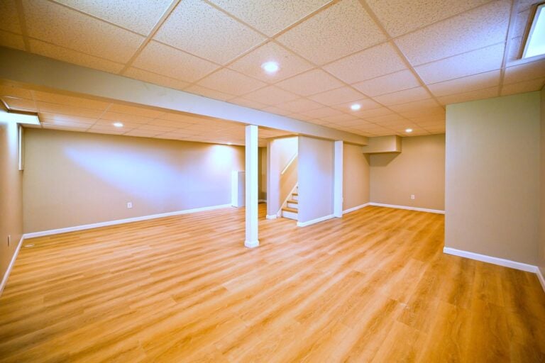 Refinished Ypsilanti basement with a drop ceiling and wood-look plank flooring