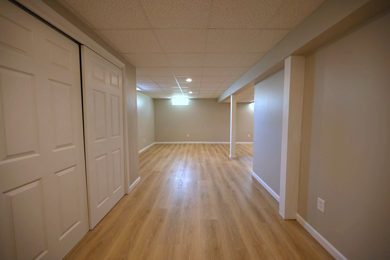 Sliding closet doors along a refinished basement hallway in Ypsilanti