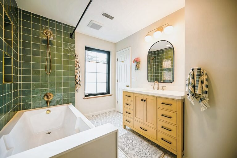 Bathroom remodel in Dexter with green tile, brass fixtures and a walk-in shower