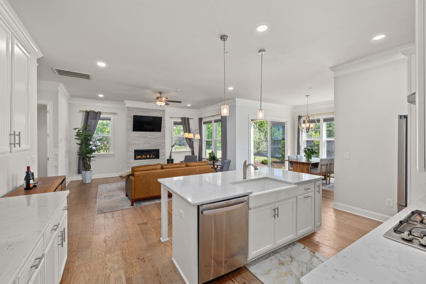 Open-plan kitchen and living room with a white island, where a dividing wall once would have stood