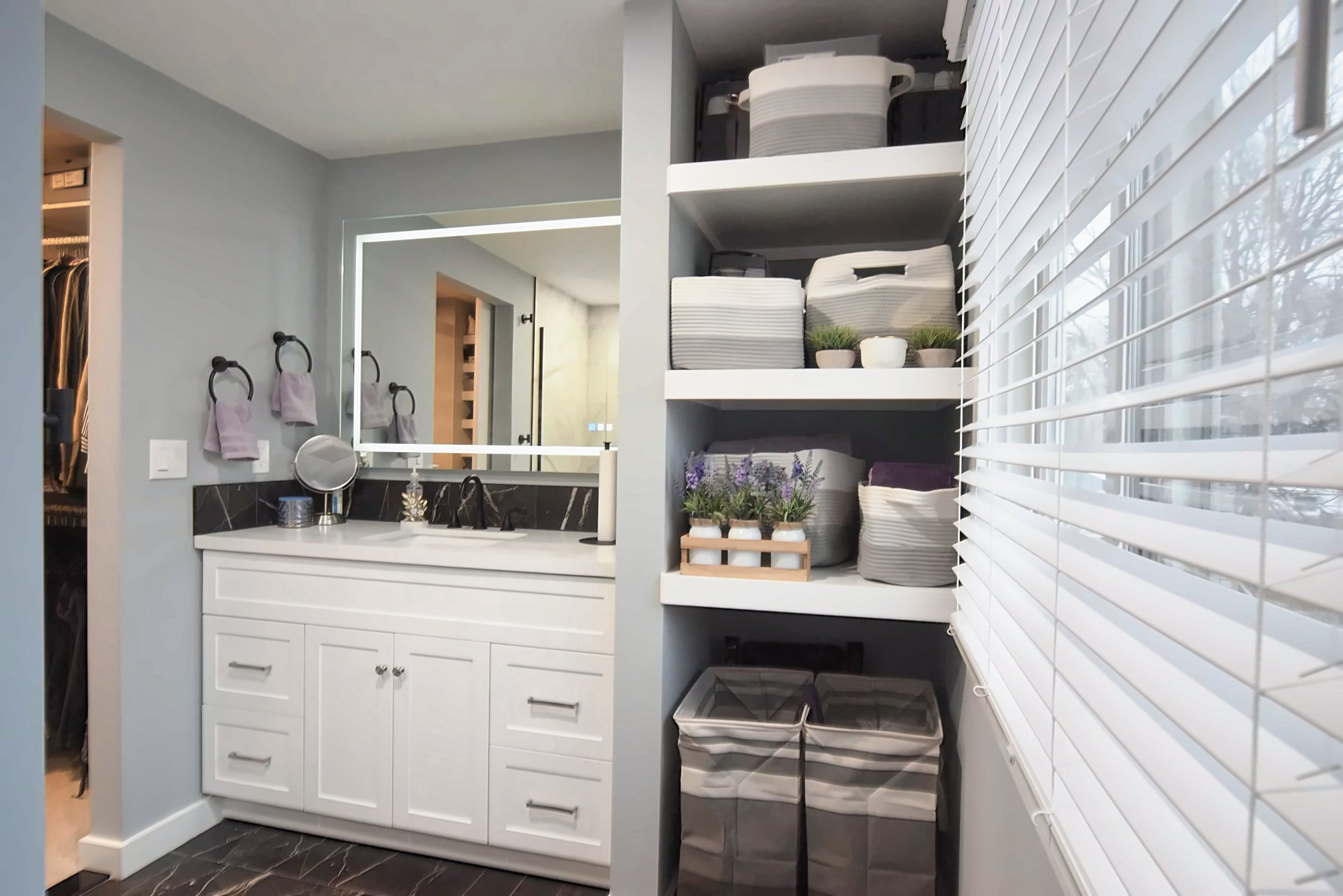 Remodeled Livonia bathroom with a floating vanity and backlit mirror