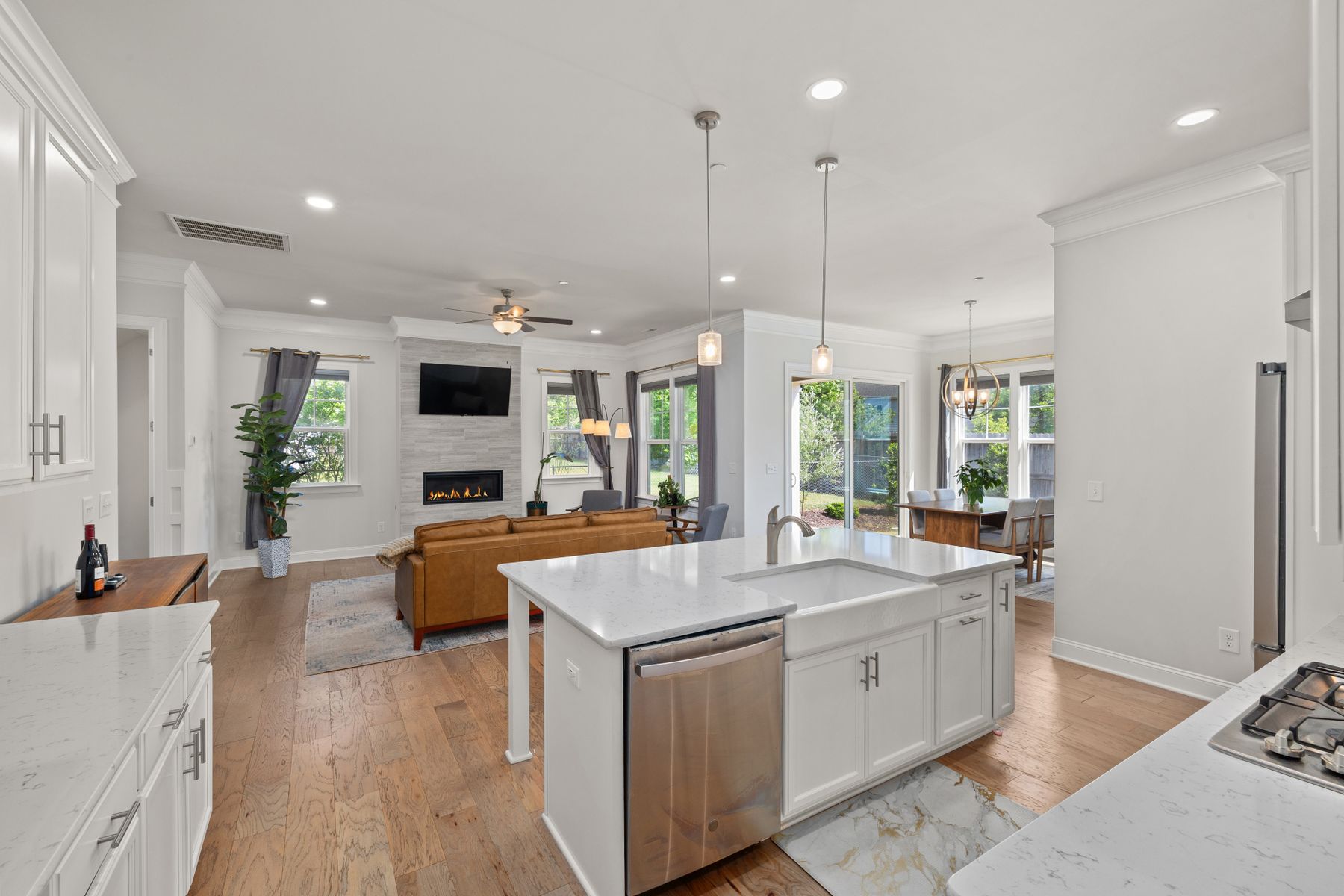 Open-plan kitchen and living room with a white island, where a dividing wall once would have stood