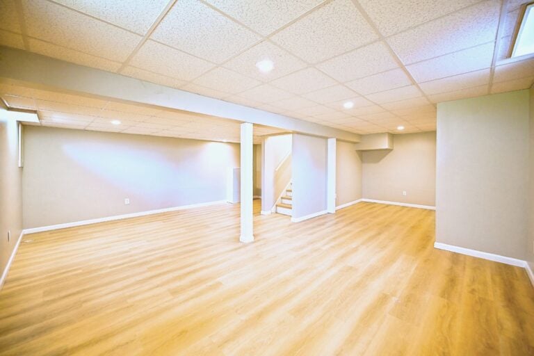 Refinished Ypsilanti basement with a drop ceiling and wood-look plank flooring